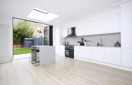 Open-concept living, dining, and kitchen area with a black and white color scheme, high-contrast furnishings, and modern design.