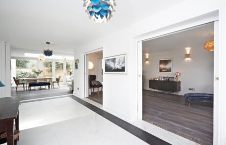 Entrance hall with black and white color scheme and a modern pocket door.